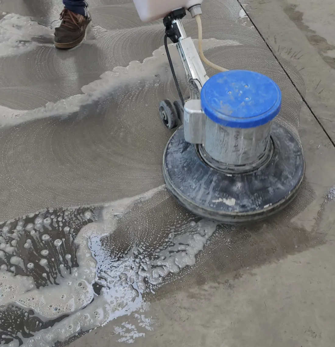 Operario de Magik Clean puliendo y abrillantando un piso con máquina rotativa en Rancagua